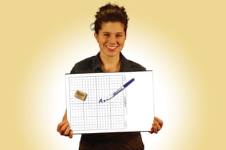 Photo of a teacher holding a graph board